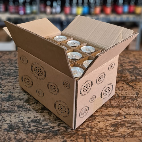 Premium craft beer cans in a subscription box displayed on an oak table