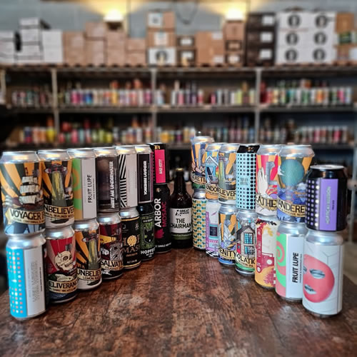 Gluten free craft beer in cans and bottles displayed on an oak table